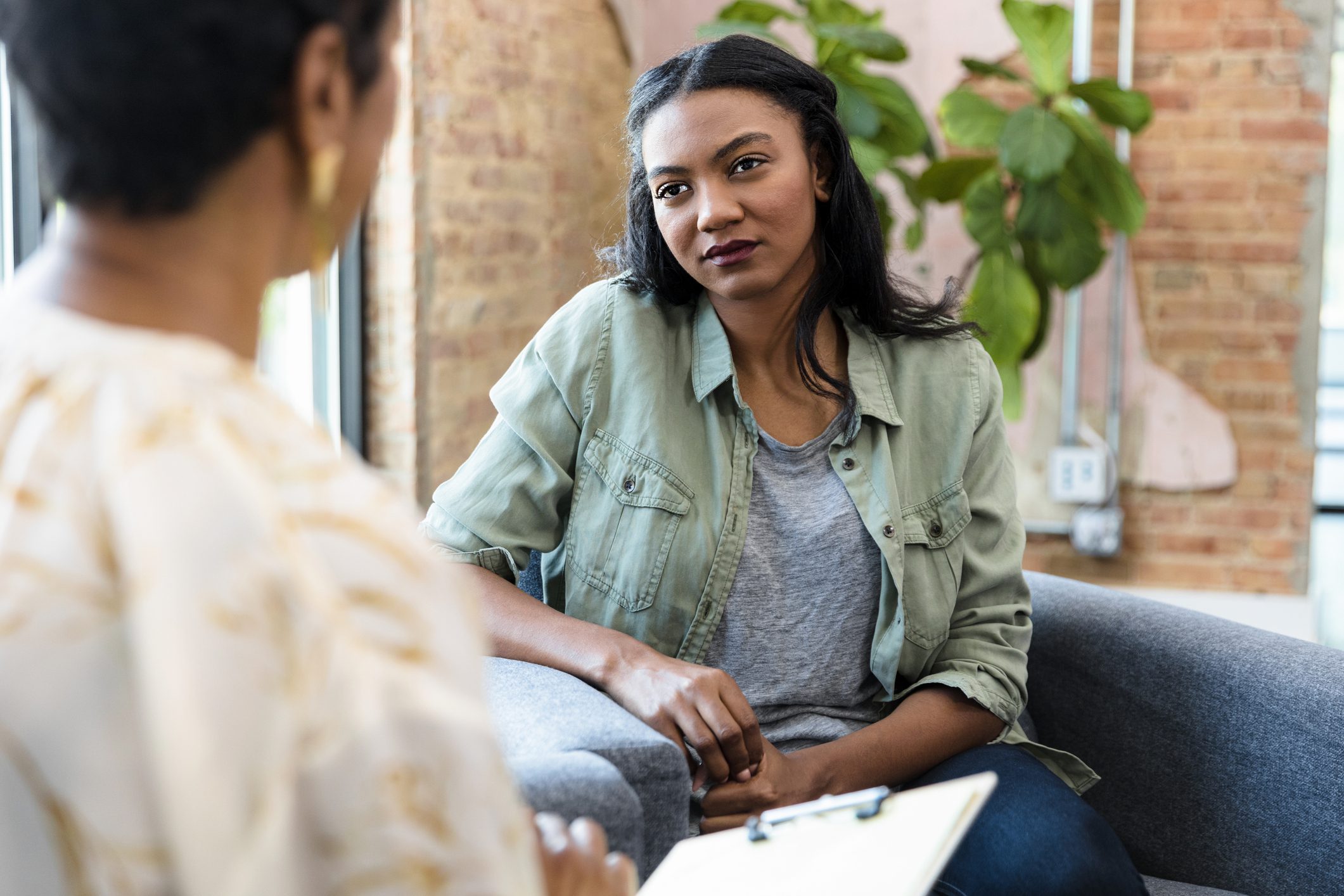 A patient in individual therapy listens attentively as she sits across her therapist.